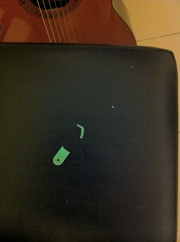 The broken green plastic piece — and a good one for comparison